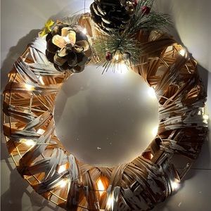 11” Hanging Light Wreath with Pinecones. Brown left-like Material w Faux Snow.